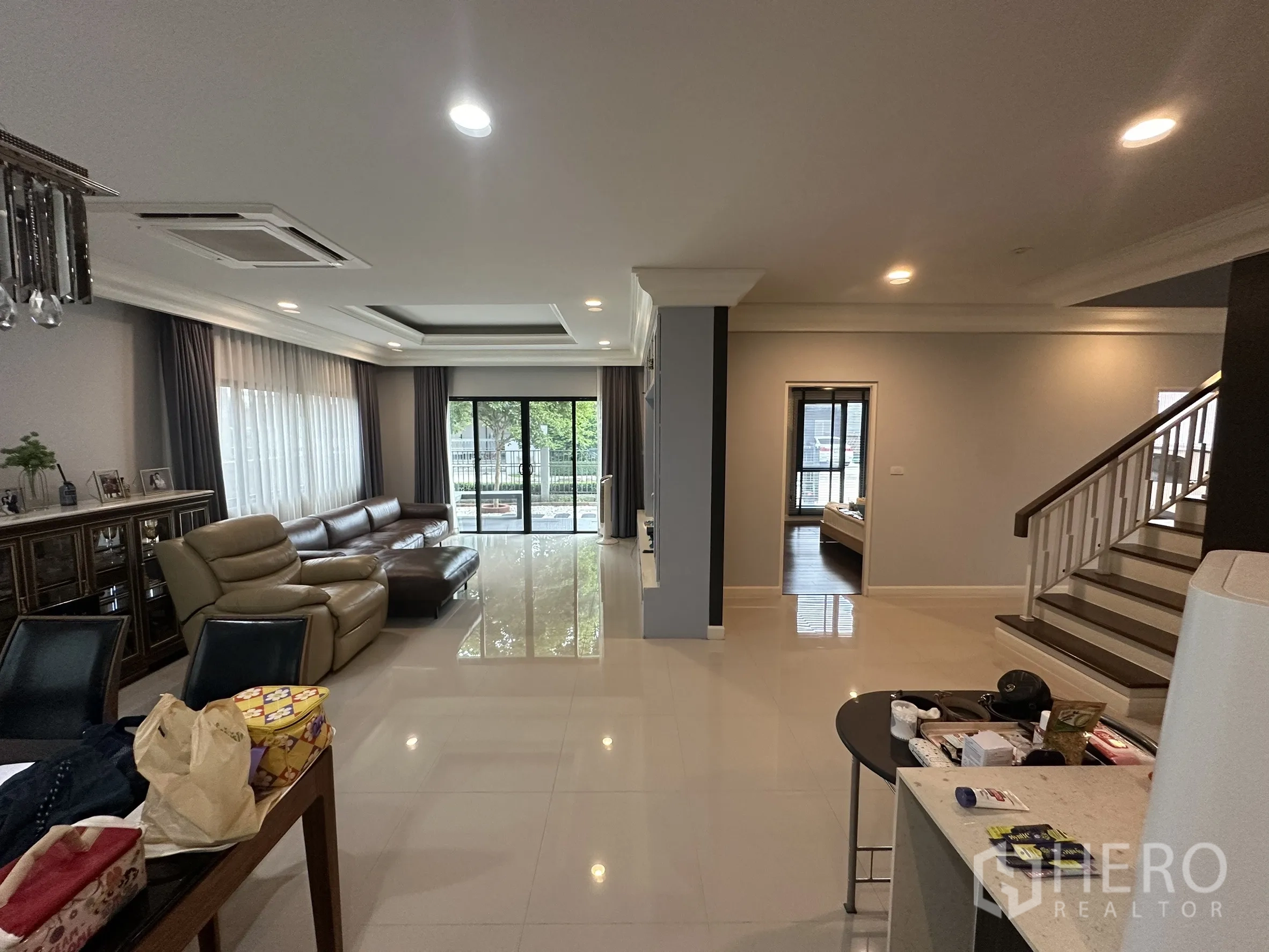 Detached House for rent in Lam Luk Ka, Pathum Thani - Open-plan ground floor with lounge, sliding doors and staircase.
