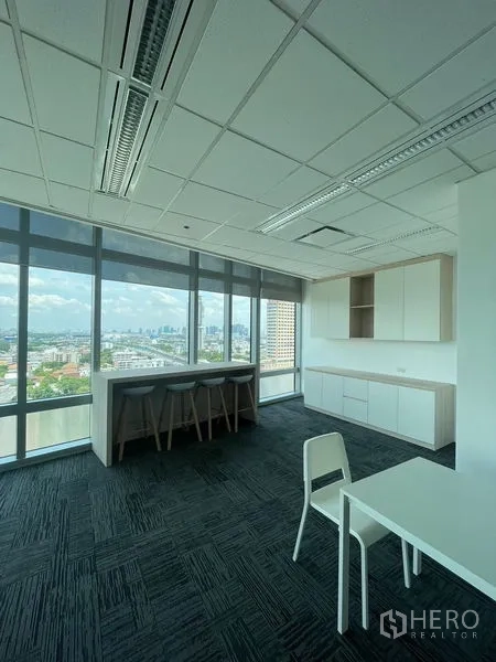 Office Space for rent in Dusit, Bangkok - Pantry and casual bar seating beside floor-to-ceiling windows overlooking the city.
