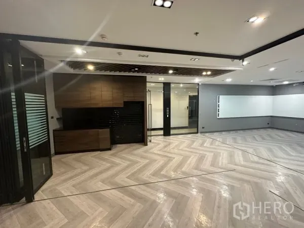Office Space for rent - Main workspace featuring a pantry, glass doors and wall-mounted whiteboard area.