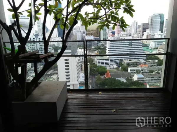 公寓 出租在Sathon, Bangkok - 私人阳台木地台与玻璃栏杆，俯瞰隆比尼附近的曼谷天际线。
