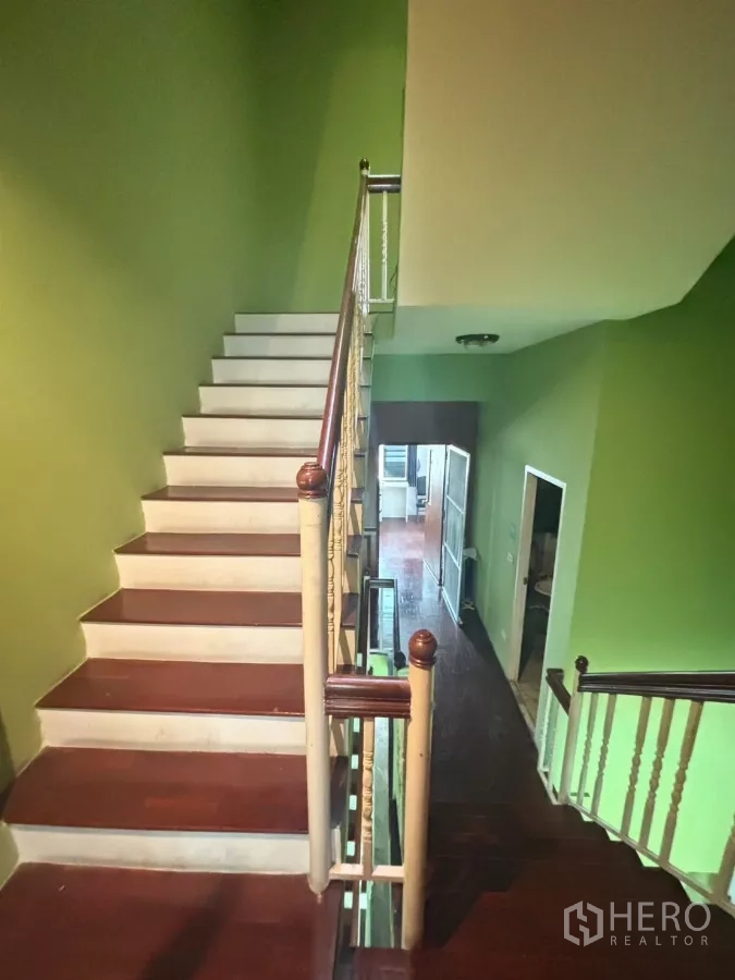 Shophouse for rent in Watthana, Bangkok - Timber staircase and corridor connecting upper floors of the shophouse.