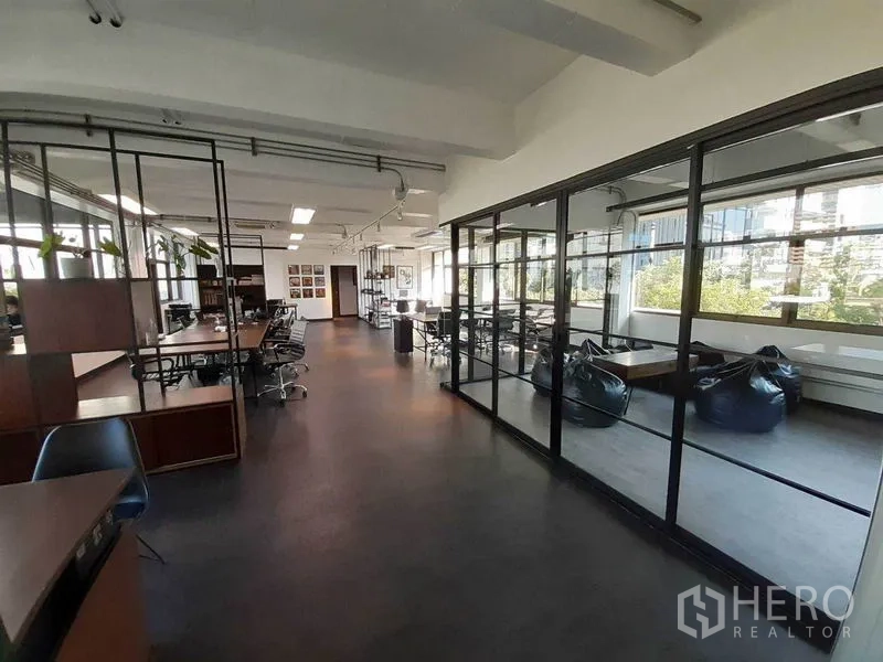 办公空间 出租在Khlong Toei, Bangkok - 办公室走道旁设玻璃会议室与懒人沙发休闲区，采光充足。