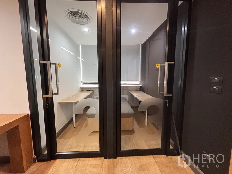 Office Space for rent in Bang Rak, Bangkok - Two private phone booths with built-in desks and bench seating behind glass doors.
