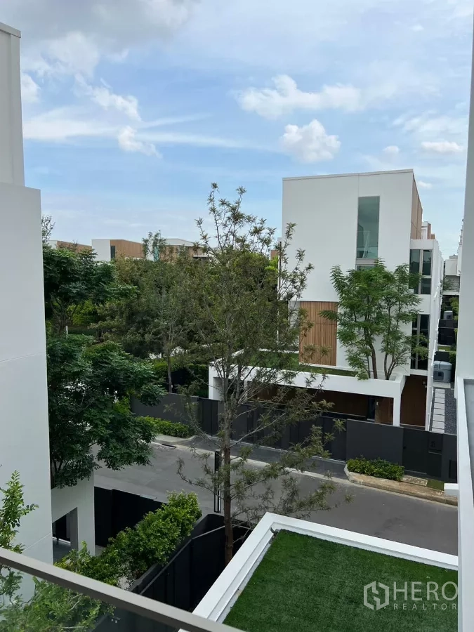 Detached House for rent in Saphan Sung, Bangkok - Upper-floor balcony view over a tree-lined street and modern homes.