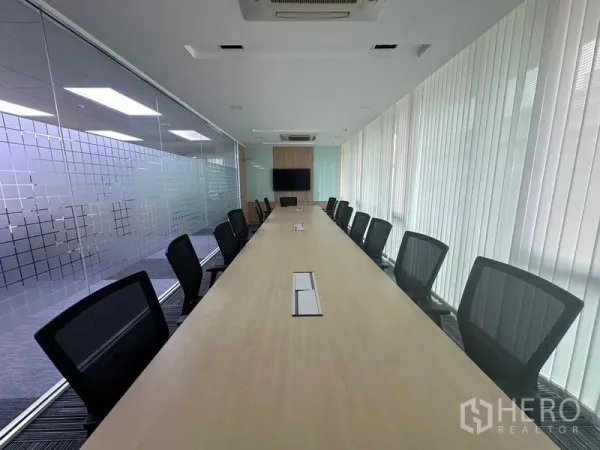 สำนักงาน ให้เช่า - ห้องบอร์ดรูมขนาดใหญ่ โต๊ะประชุมยาว เก้าอี้ตาข่าย และจอแขวนผนัง