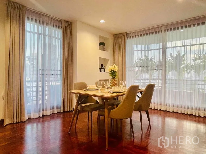 Condominium for rent - Corner dining nook with four chairs by wraparound windows.