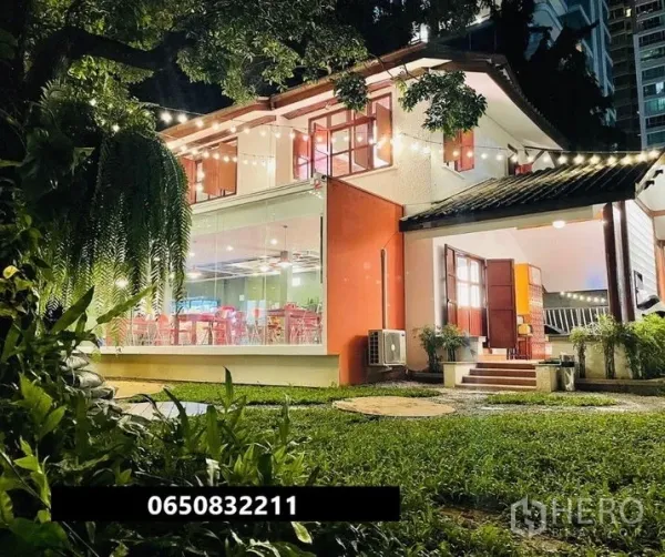 Retail Space for rent in Pathum Wan, Bangkok - Two-storey glass-fronted retail house with lawn and festoon lighting at night.