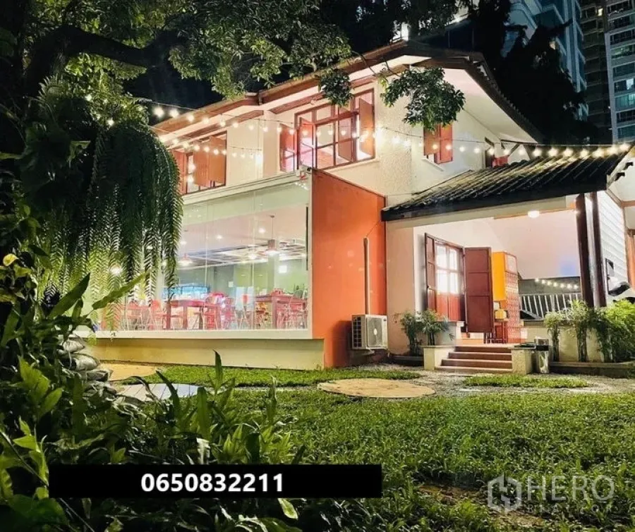 Retail Space for rent in Pathum Wan, Bangkok - Two-storey glass-fronted retail house with lawn and festoon lighting at night.