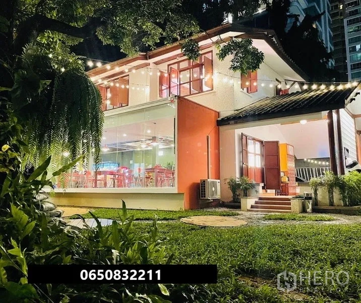 Retail Space for rent in Pathum Wan, Bangkok - Two-storey glass-fronted retail house with lawn and festoon lighting at night.