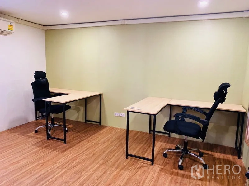 Office Space for rent in Bang Rak, Bangkok - Quiet room with twin L-shaped desks and ergonomic chairs.