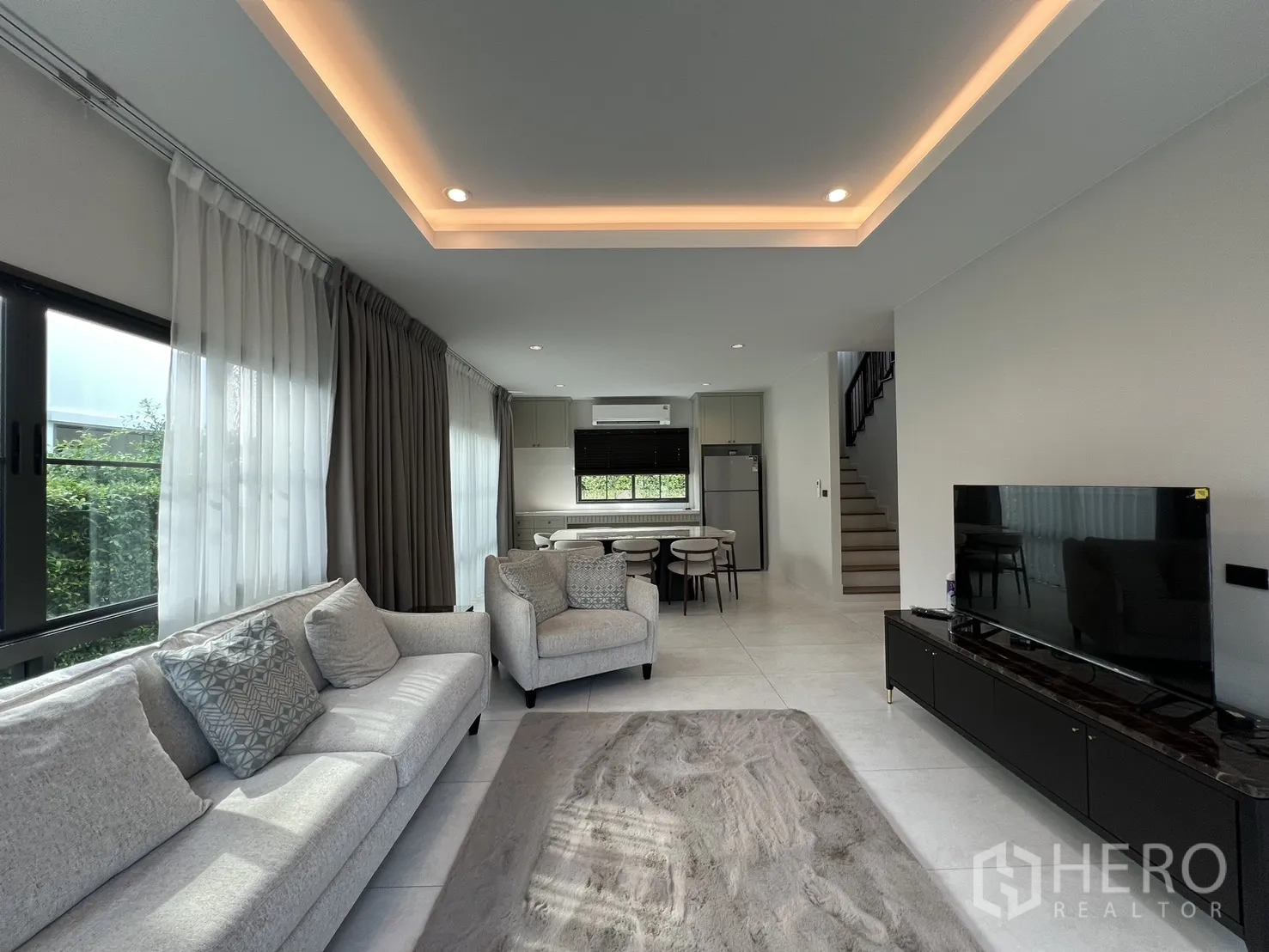 Detached House for rent in Bang Phli, Samut Prakan - Living room view toward the dining area and staircase.