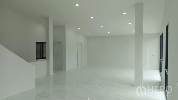 Warehouse for rent or sale in Lam Luk Ka, Pathum Thani - Bright ground-floor office with white marble-look tiles and recessed LED lighting.