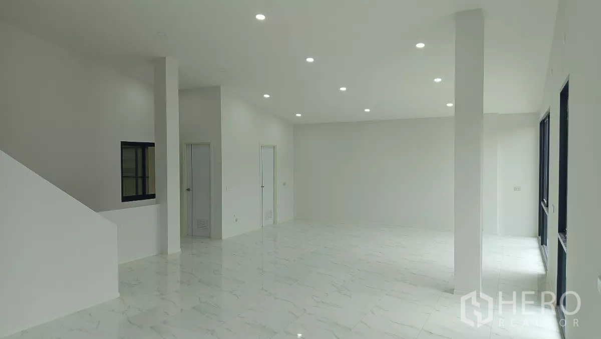 Warehouse for rent or sale in Lam Luk Ka, Pathum Thani - Bright ground-floor office with white marble-look tiles and recessed LED lighting.