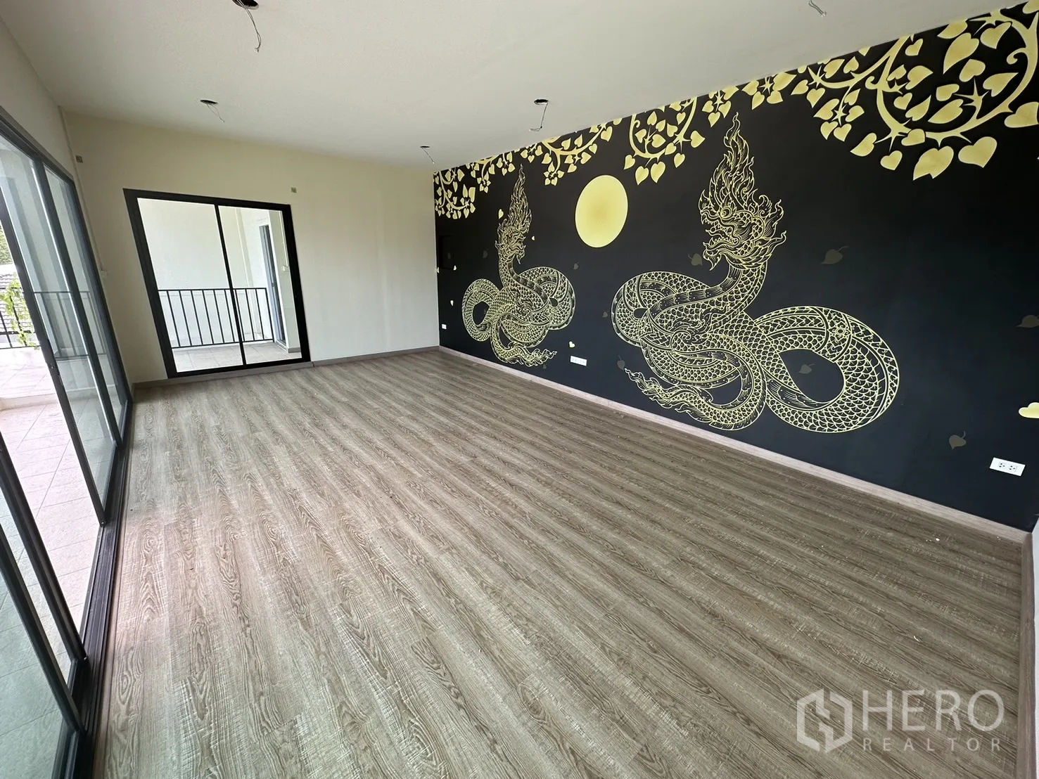 Warehouse for rent in Suan Luang, Bangkok - Office room featuring a decorative Thai mural and sliding doors to a balcony.