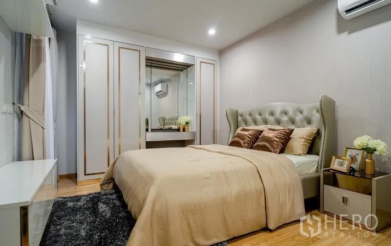 Detached House for sale in Lam Luk Ka, Pathum Thani - Second bedroom with upholstered headboard and wardrobe.