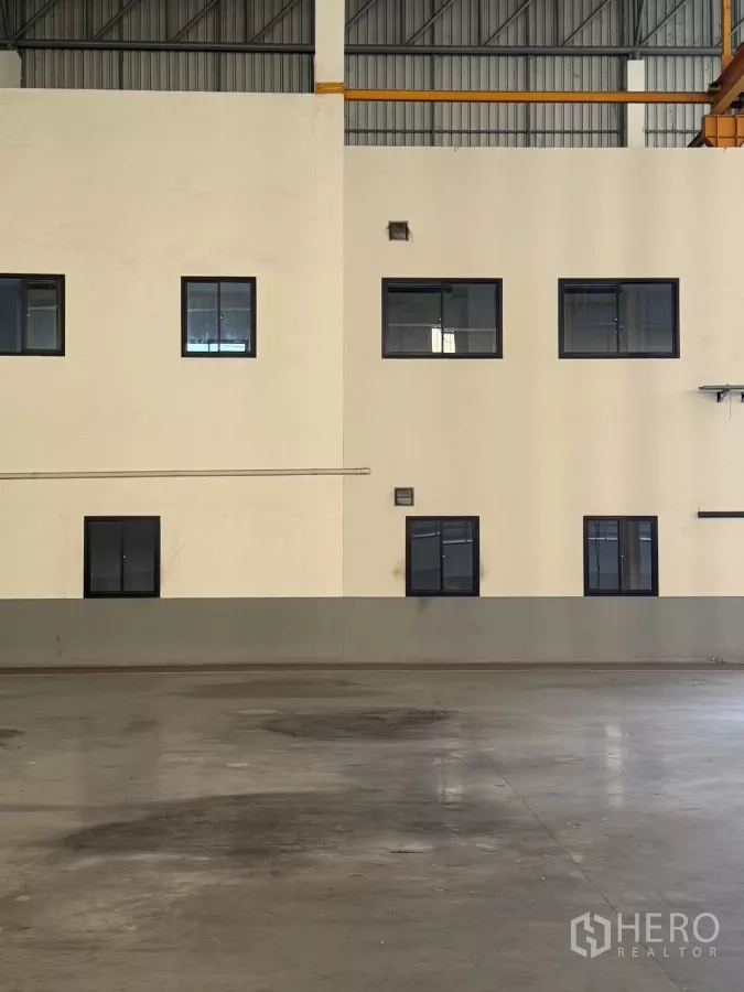 Factory for rent or sale in Bang Phli, Samut Prakan - Close-up of two-storey office windows inside the factory hall.