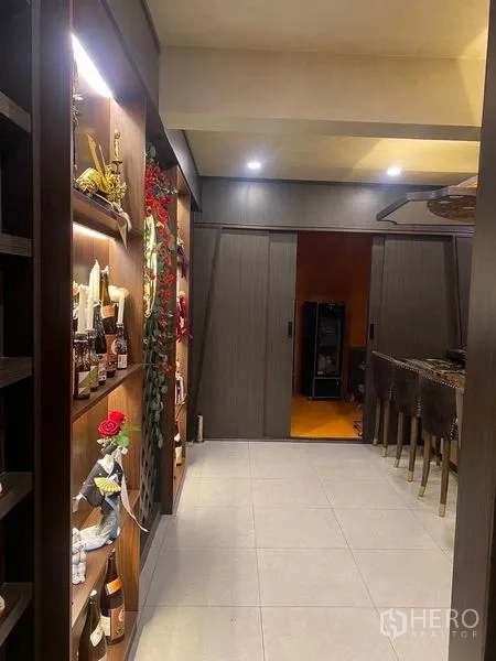 Shophouse for rent - Corridor with sliding doors leading to the bar and display shelving.