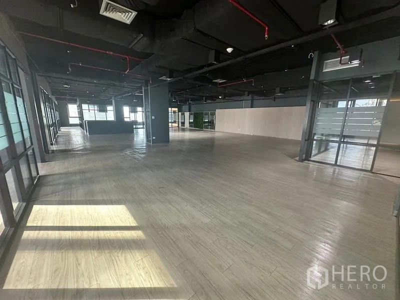 办公空间 出租在Bang Rak, Bangkok - 开放式办公室全景，可见接待岛台与外围玻璃立面。