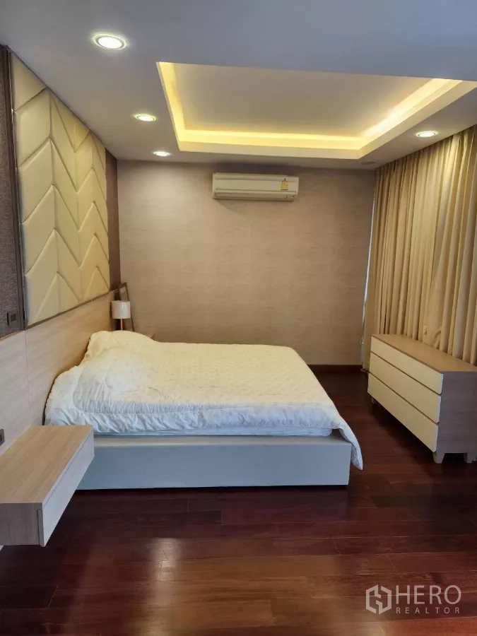 Detached House for rent or sale in Chatuchak, Bangkok - Master bedroom with recessed ceiling lighting and wood floors.