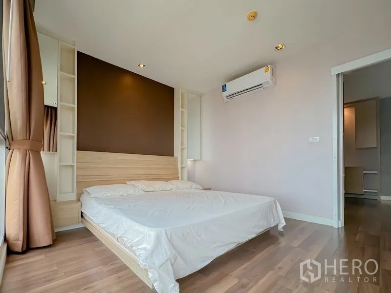 Condominium for sale - Master bedroom corner with accent wall, air conditioner and curtains.