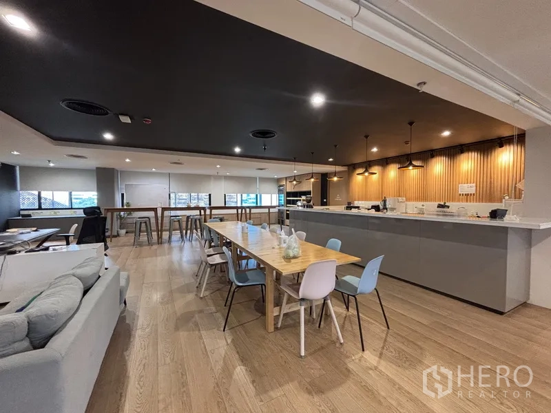 Office Space for rent in Bang Rak, Bangkok - Pantry and dining area with long tables, bar stools, and pendant lighting.