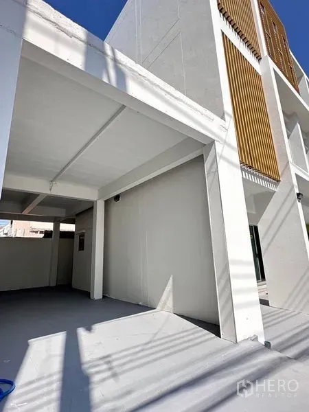 Home Office for sale in Lat Krabang, Bangkok - Spacious covered parking bay with open sides and slatted wood exterior detail.