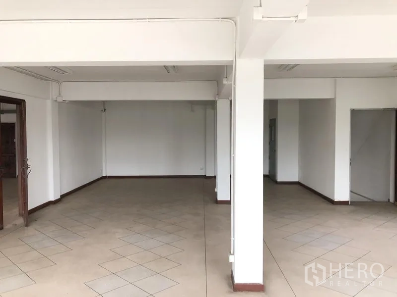 Office Space for rent in Huai Khwang, Bangkok - Open office floor with patterned tiles and multiple entryways.