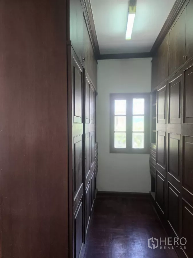 Detached House for rent in Phra Khanong, Bangkok - Ground-floor multipurpose room with built-in cabinet divider and marble floor.