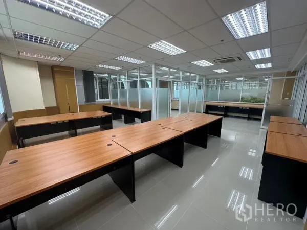 Office Space for rent in Suan Luang, Bangkok - Spacious office area featuring multiple workstations, tiled floors and glass-partitioned rooms for teams.