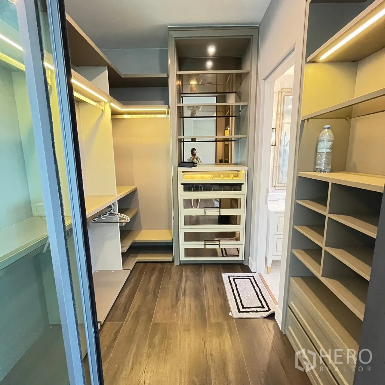 Detached House for rent or sale in Bang Khen, Bangkok - Walk‑in closet with illuminated shelves and mirror cabinetry.