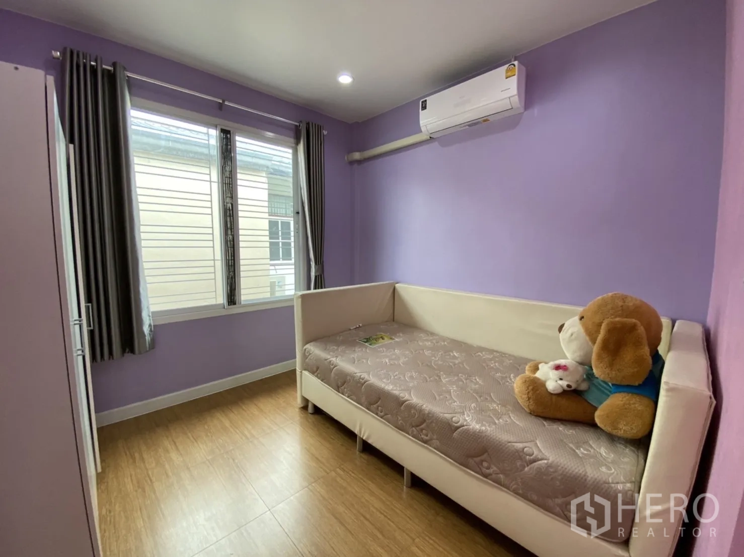Townhouse for rent or sale - Cozy bedroom with purple walls, window and air conditioner.