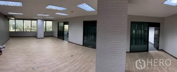 Office Space for rent in Bang Na, Bangkok - Open-plan 126 sqm office with wood-look floors, large windows and ceiling lights plus glass-partition rooms.