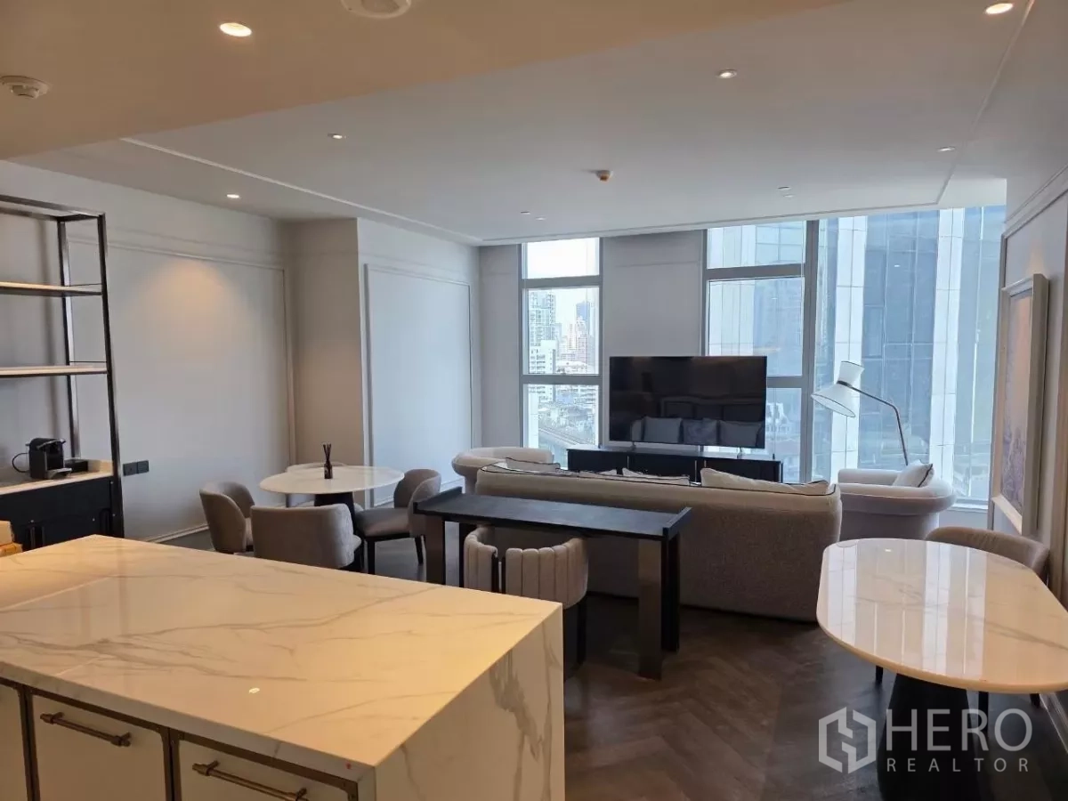 Condominium for rent - Kitchen and living overview with marble islands, shelving, and wide window views.