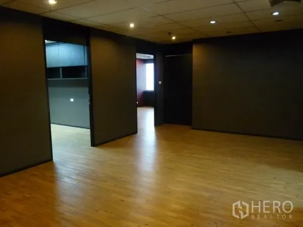 Office Space for sale in Watthana, Bangkok - Open-plan office with wooden floors and partitioned rooms, suitable for workstations and meeting space.