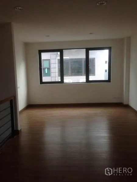 Home Office for rent in Bang Phli, Samut Prakan - Upper floor room with wood flooring and a wide window for natural light.