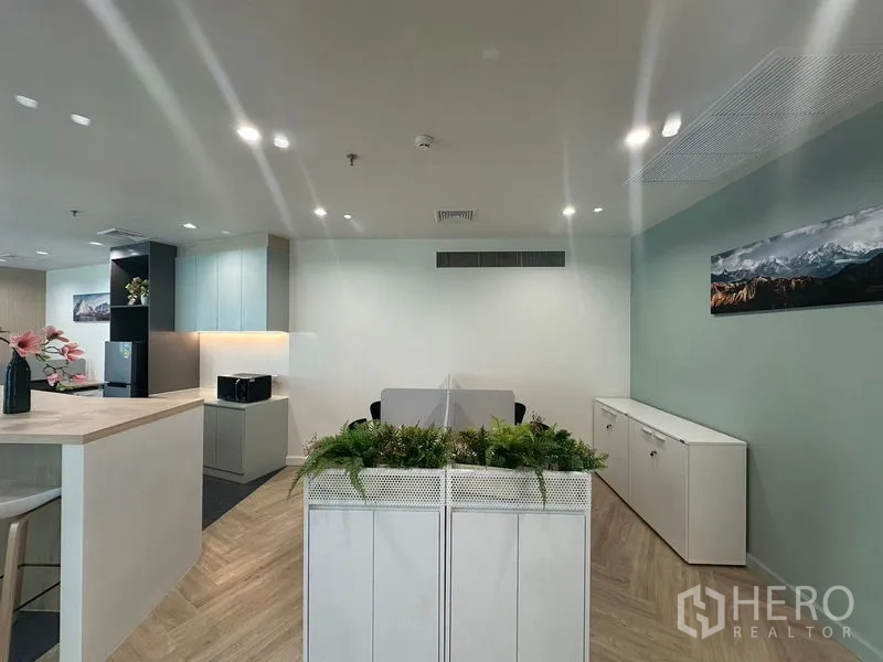 Office Space for rent - View into glass office from open workspace with planters and built-in shelves.