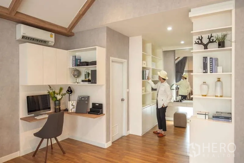 Detached House for sale in Lam Luk Ka, Pathum Thani - Built-in home office area with shelving and storage connected to bedroom.