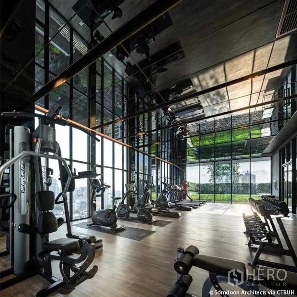 Condominium for rent - Fully equipped fitness center with cardio machines, weights and floor-to-ceiling windows.
