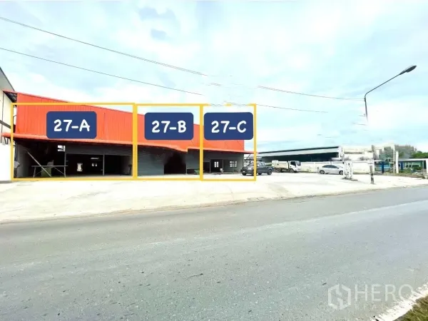 Warehouse for rent in Lam Luk Ka, Pathum Thani - Roadside view of the warehouse complex showing sections labeled 27-A, 27-B and 27-C with parking area.