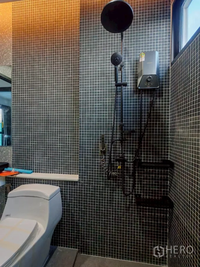 Detached House for rent in Wang Thonglang, Bangkok - Mosaic-tiled bathroom with rain shower, handheld shower, and toilet.