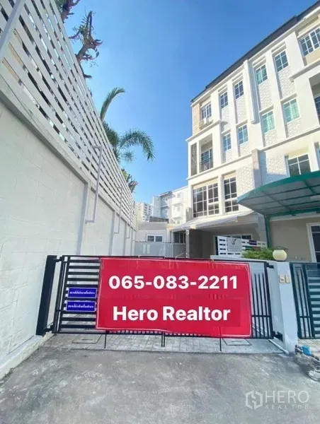 Home Office for rent or sale - Gated entrance of a four-storey home office townhouse with a red sale banner and driveway.