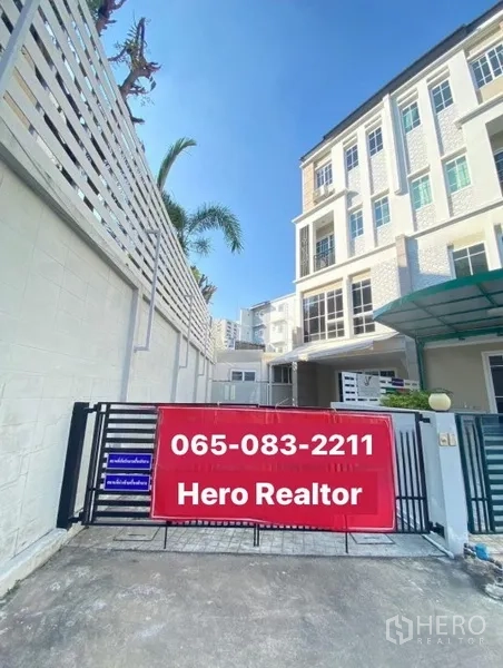 Home Office for rent or sale - Gated entrance of a four-storey home office townhouse with a red sale banner and driveway.