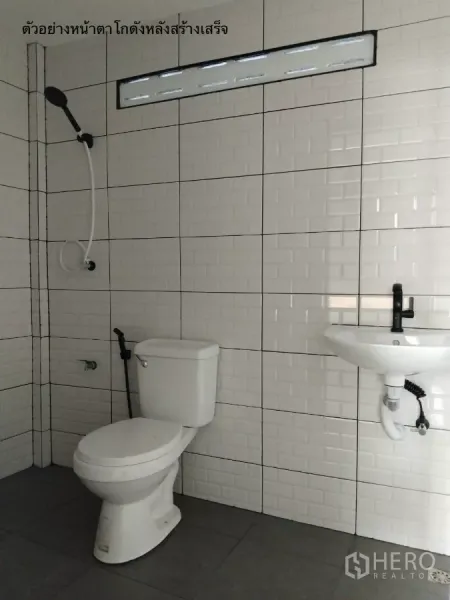 Warehouse for rent in Bang Kapi, Bangkok - Clean tiled restroom inside the warehouse with toilet, sink and shower set.