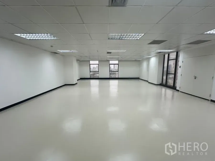 Office Space for rent - Wide shot of 116 sqm office space featuring natural light from two sides and ceiling light panels.