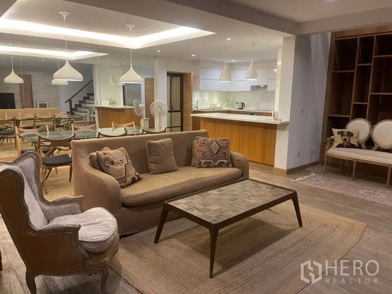 Townhouse for rent in Suan Luang, Bangkok - Open-plan living and dining area with modern kitchen, breakfast bar and pendant lighting.