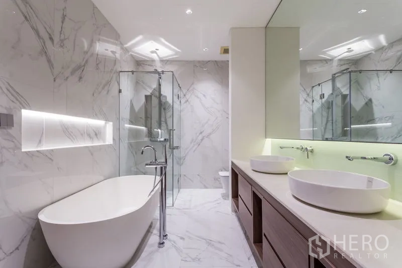 Condominium for rent in Khlong Toei, Bangkok - Luxury bathroom with freestanding bathtub, glass shower and double vanity.