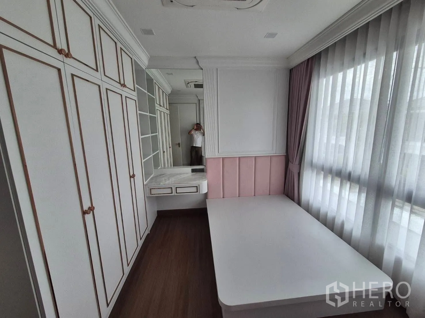 Detached House for sale in Bang Kruai, Nonthaburi - Bedroom with built‑in wardrobes, dressing table and large curtained windows.