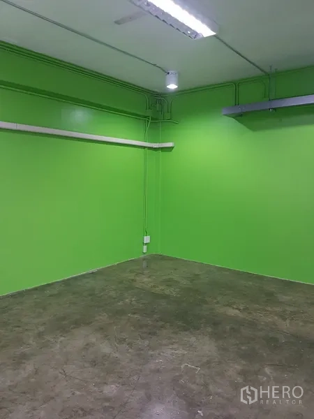 Home Office for sale in Khlong Toei, Bangkok - Green office room with large window and concrete floor.