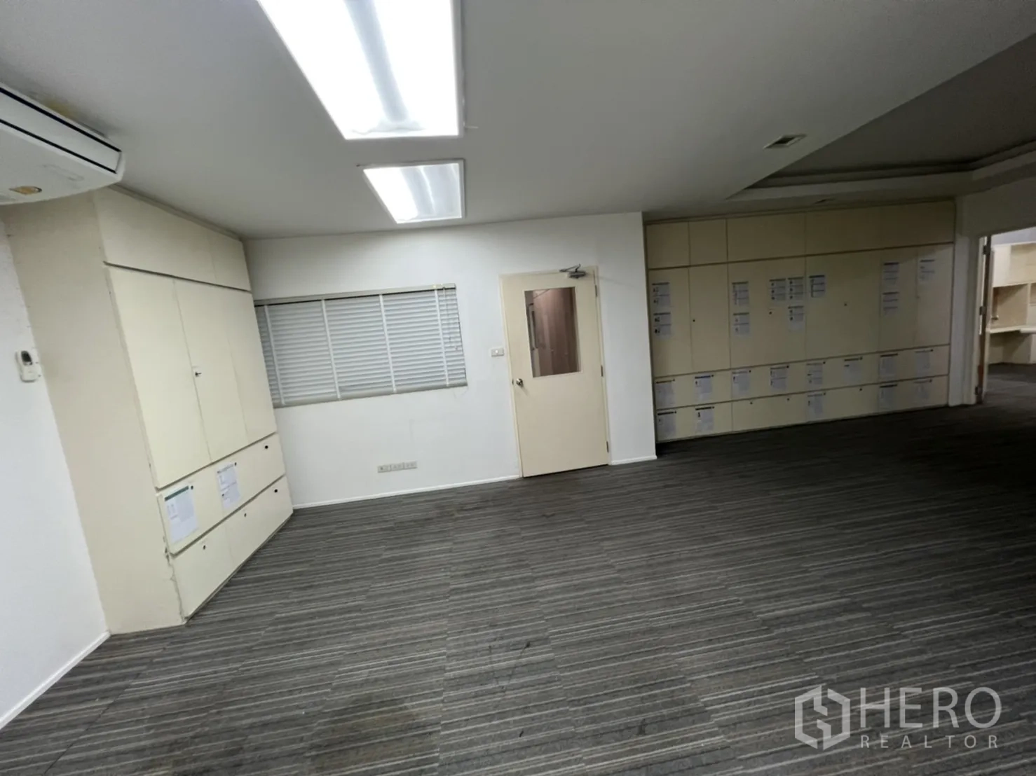 Shophouse for rent or sale in Watthana, Bangkok - Office with extensive built-in cabinetry and carpet tiles.