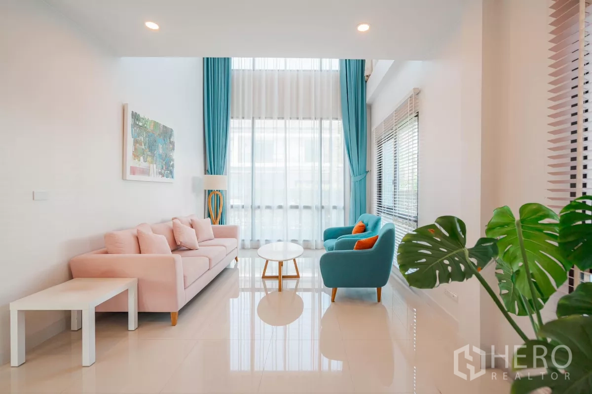 Detached House for sale in Saphan Sung, Bangkok - Double-height living room with tall sheer curtains and turquoise accents.